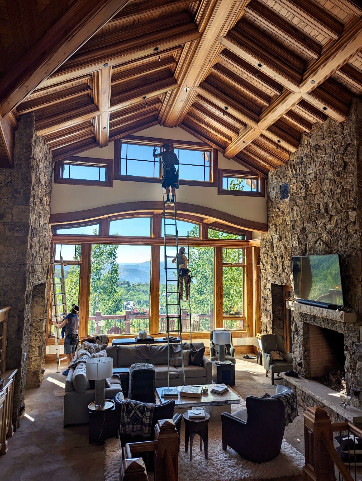 Residential window cleaning on the upper windows of a timber and stone mountain home in Bachelor Gulch, Avon, Colorado