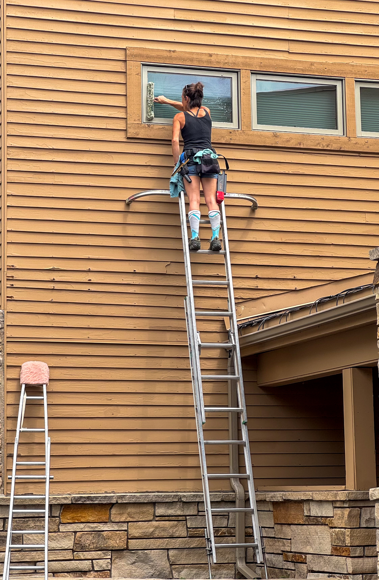 Residential window cleaning on a wood-sided home with second-story windows in Eagle-Vail, Avon, Colorado